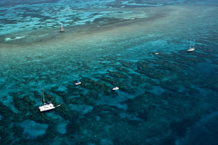 Aerial view of commercial and privately owned dive boats on Molasses Reef, Key Largo, Florida