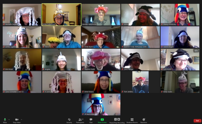 A Zoom meeting with adults wearing Halloween hats in various marine themes.